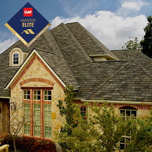 House with brown GAF shingles and the GAF Master Elite Residential Roofing Contractor logo on the top left
